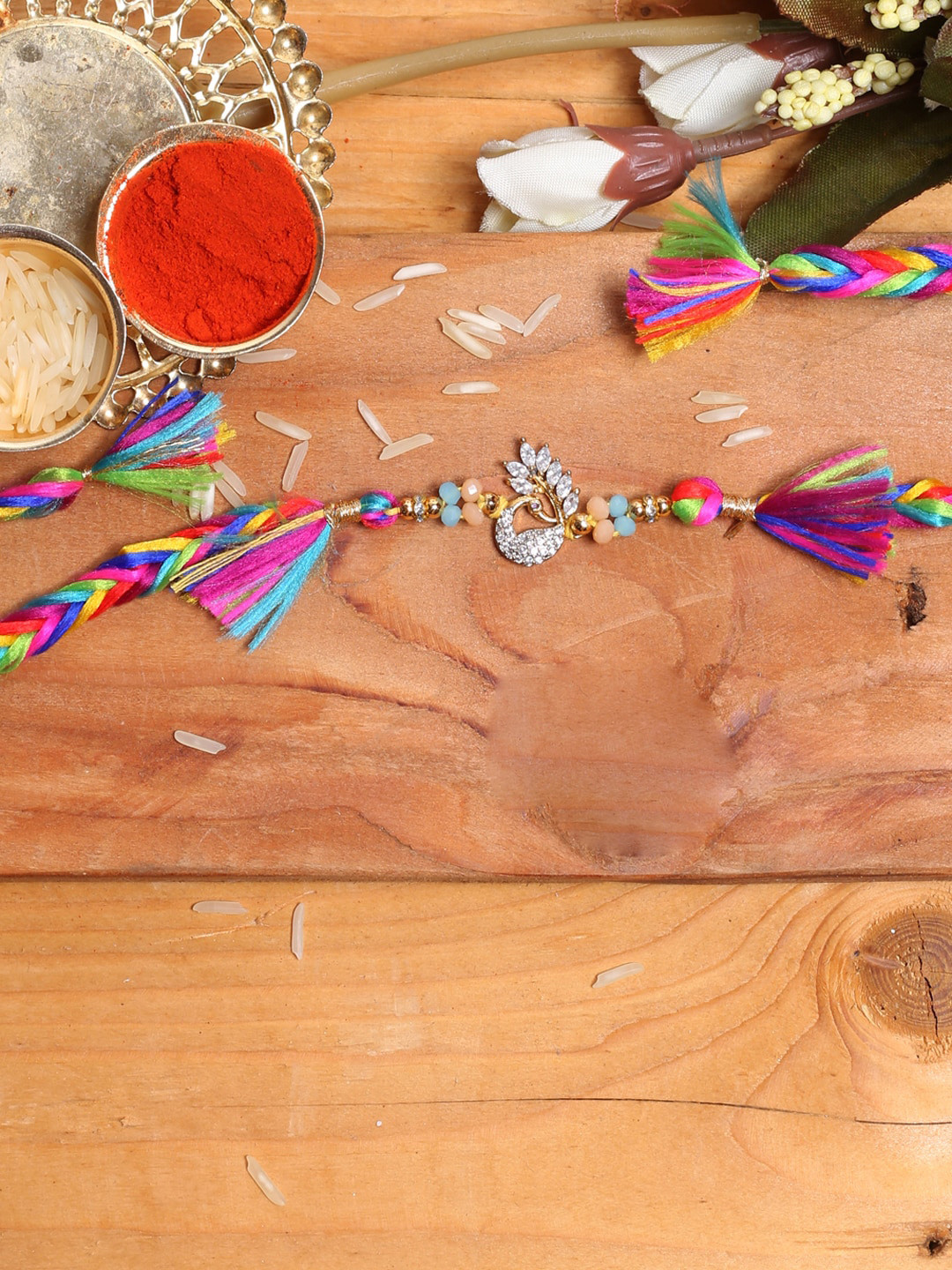 

Aapno Rajasthan Multicolored Diamond Peacock Handcrafted Thread Rakhi, Multi