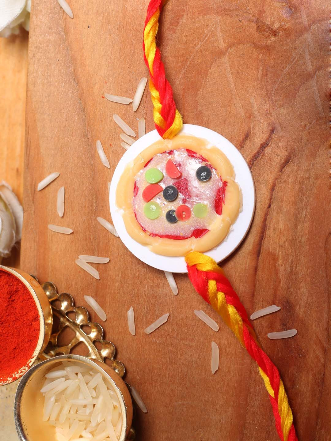 

Aapno Rajasthan Multicoloured Colourful Fruity Tart Rakhi Roli Chawal & Card, Multi