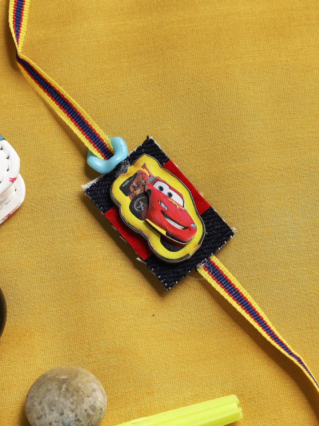 

Aapno Rajasthan Black & Red Speeding Car Rakhi For Kids