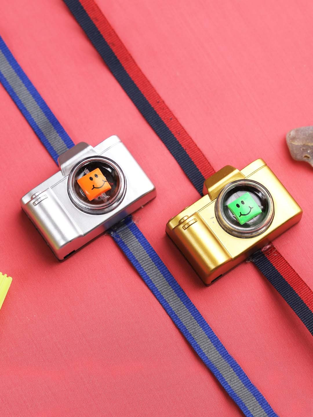 

Aapno Rajasthan Set of Two Silver and Golden Camera Rakhis