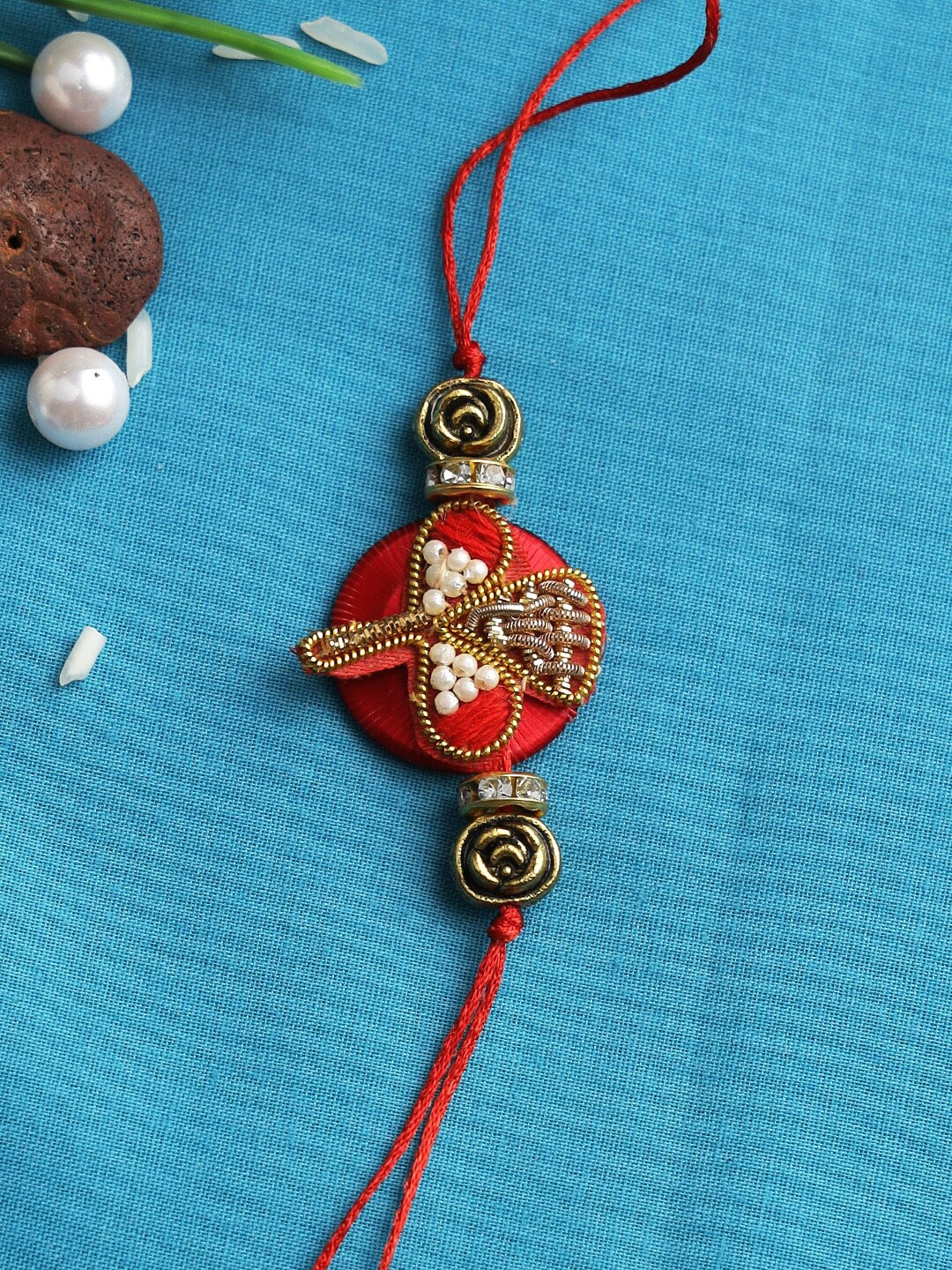 

Aapno Rajasthan Red Tulip Zardosi Rakhi With Rolichawal