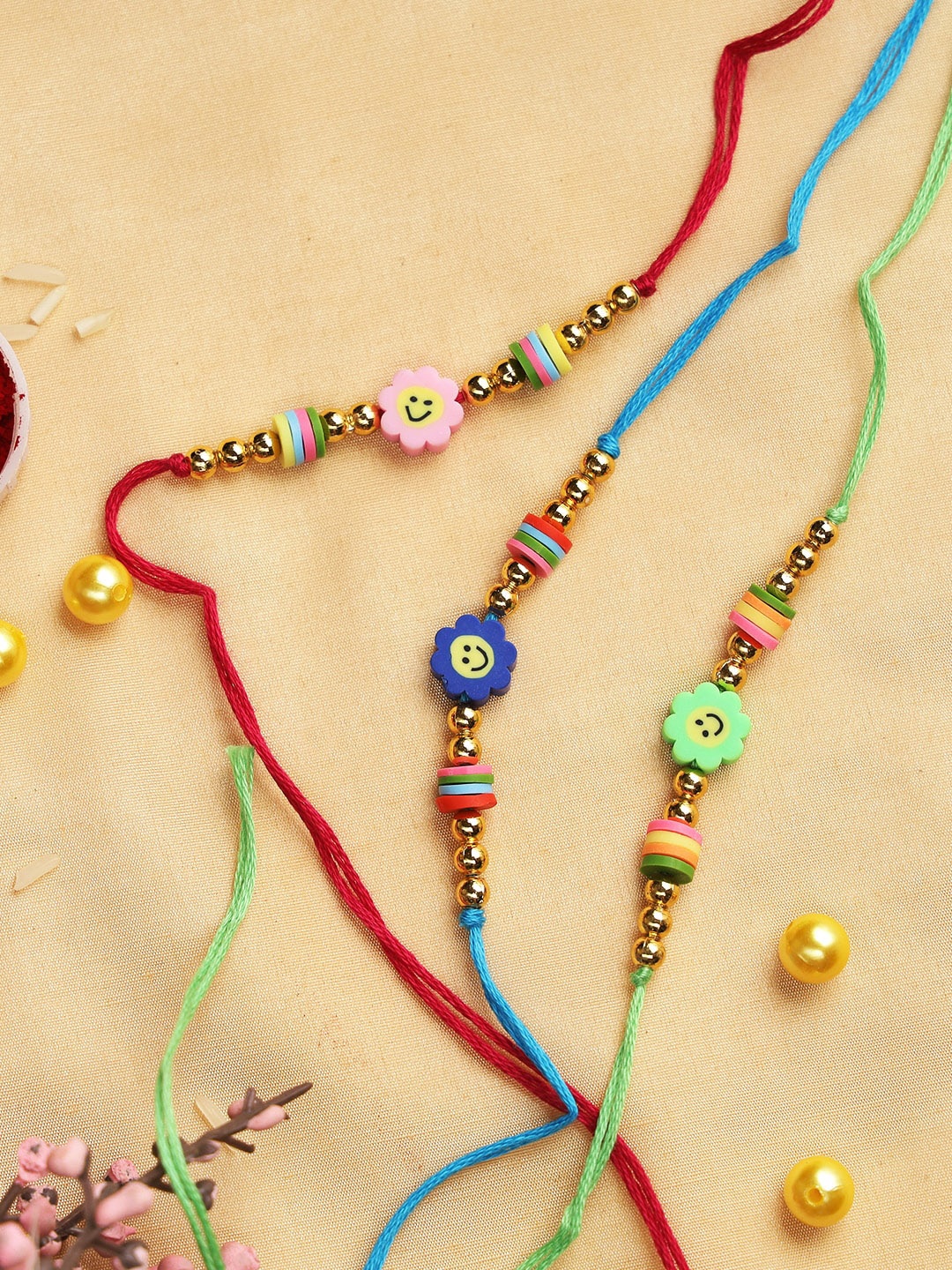 

Aapno Rajasthan Pack Of 3 Multicoloured Beaded Rakhi With Roli Chawal & Card, Red