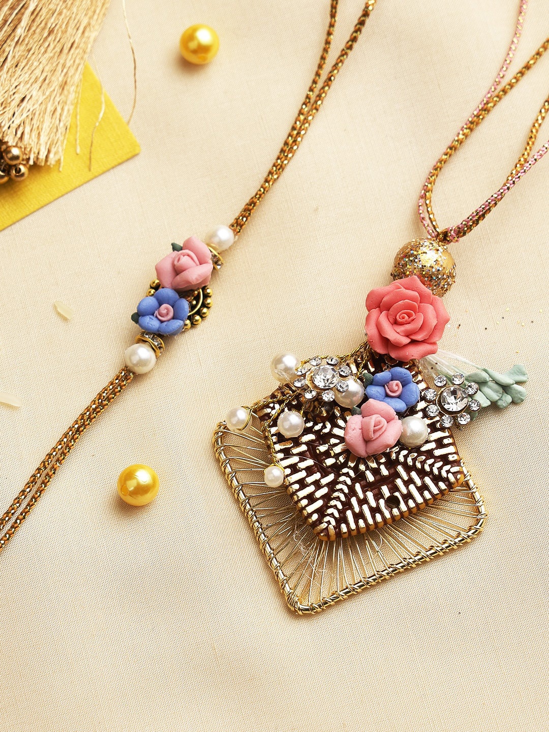 

Aapno Rajasthan Set of 2 Gold-Toned Handcrafted Pretty Little Flowers Rakhi