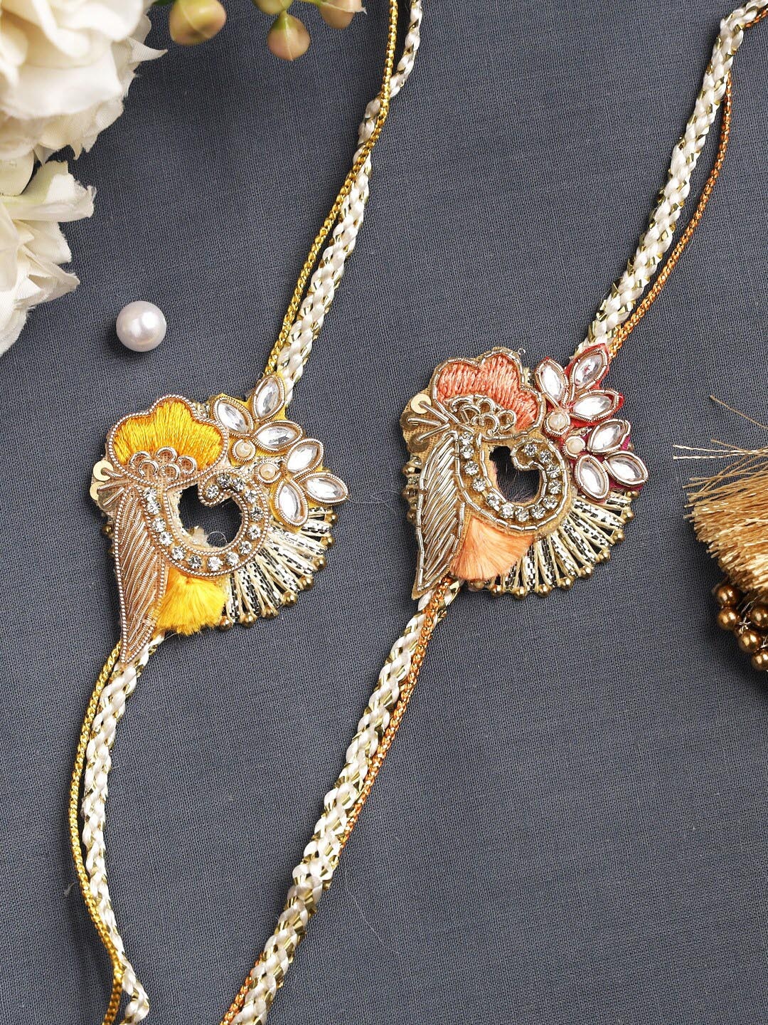 

Aapno Rajasthan Set Of 2 Yellow & Peach Studded Rakhis