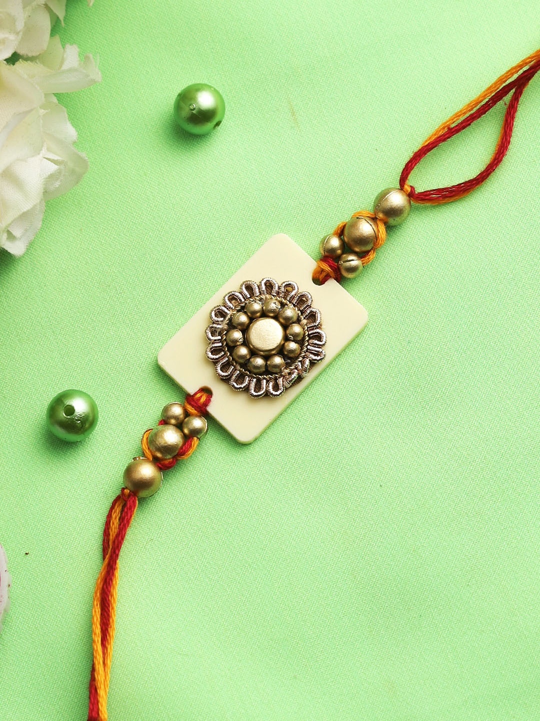 

Aapno Rajasthan Gold-Toned Antique Flower Rakhi