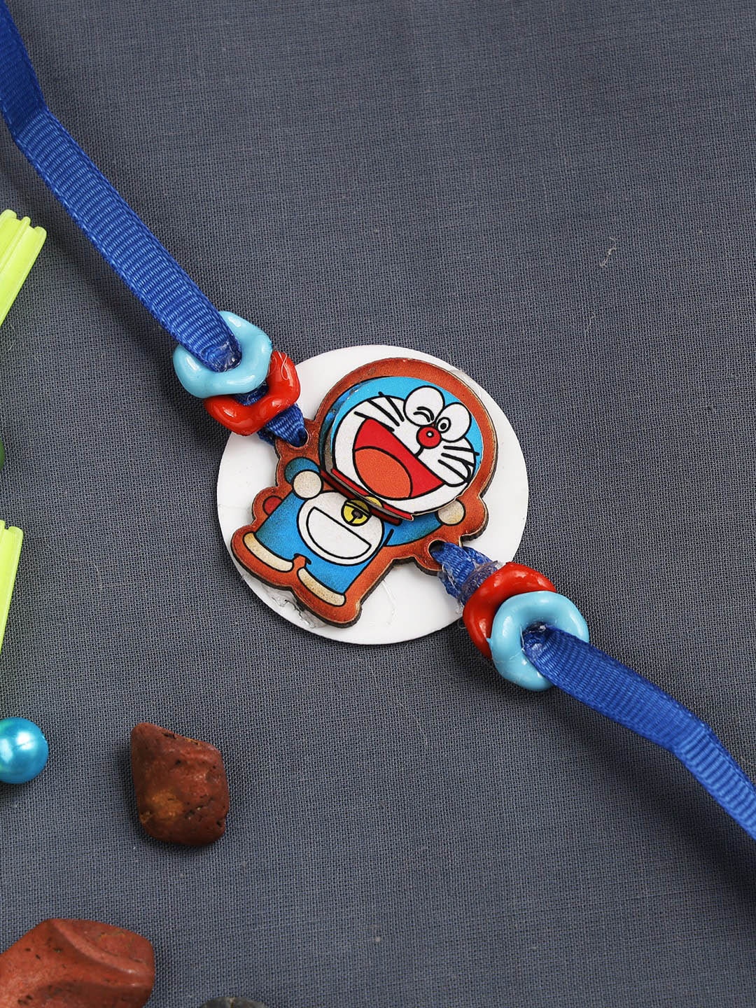 

Aapno Rajasthan Kids Red & Blue Happy Doraemon Rakhi