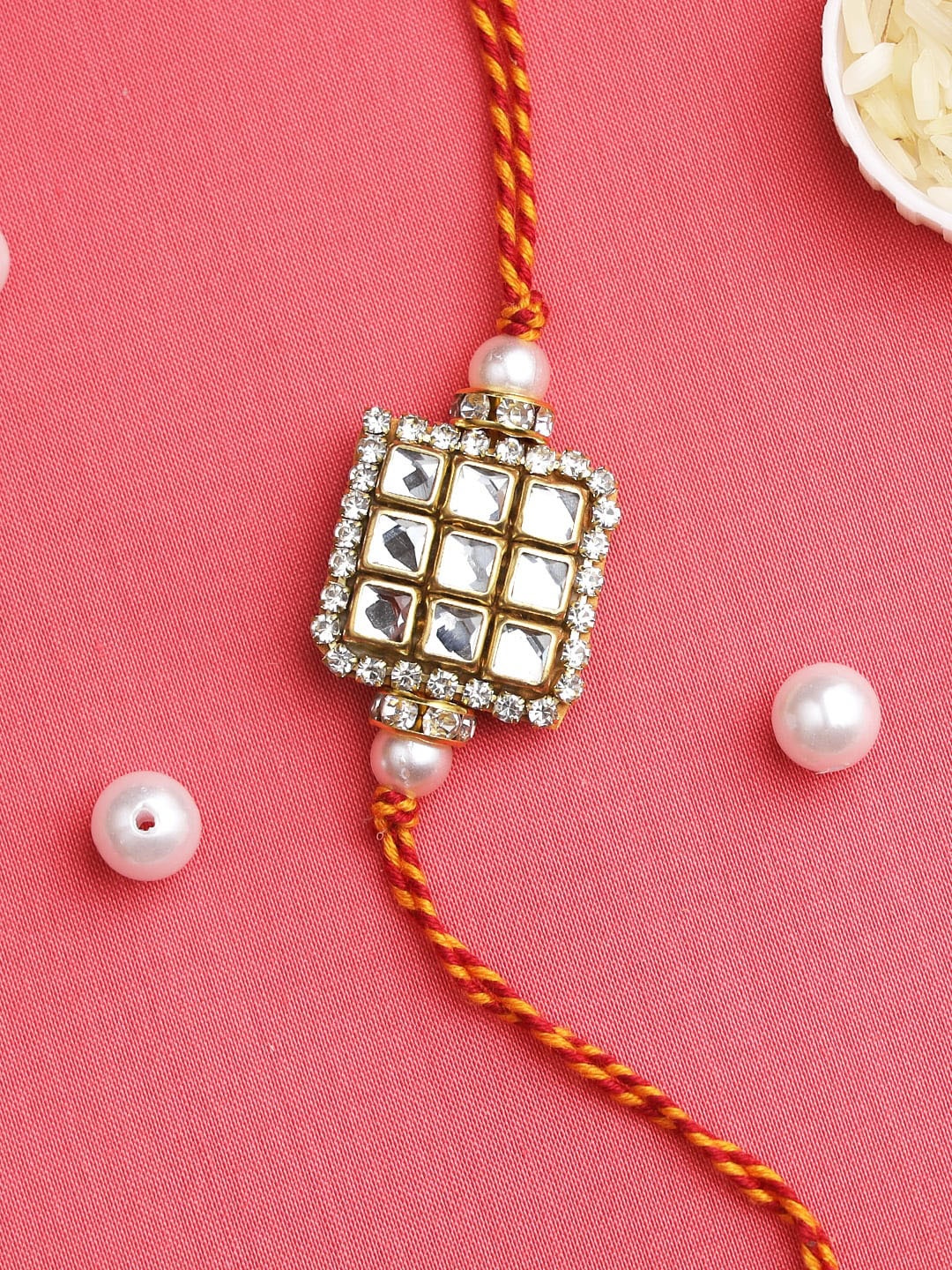 

Aapno Rajasthan White & Red Kundan Beaded Square Shaped Thread Rakhi