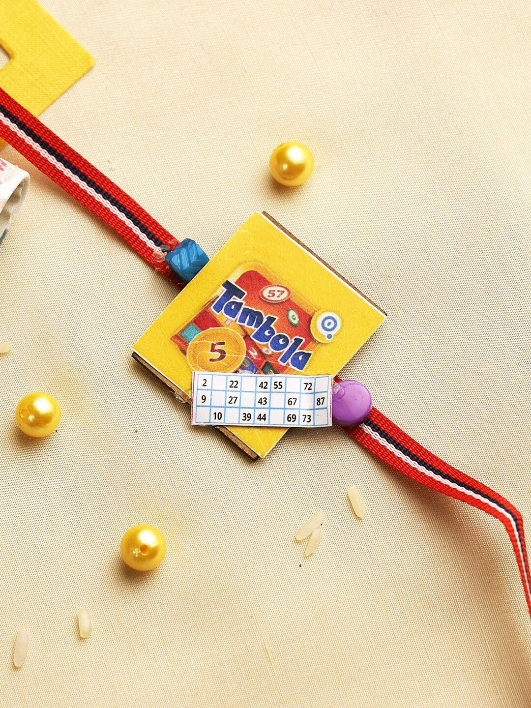 

Aapno Rajasthan Kids Yellow Tambola Rakhi