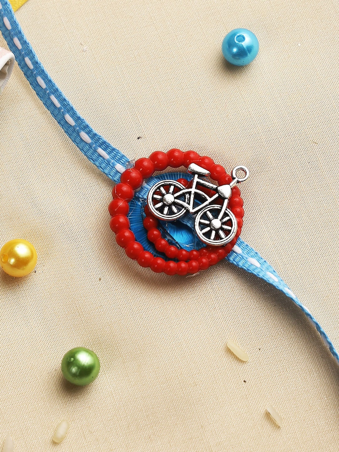 

Aapno Rajasthan Kids Red Spiral Bicycle Rakhi