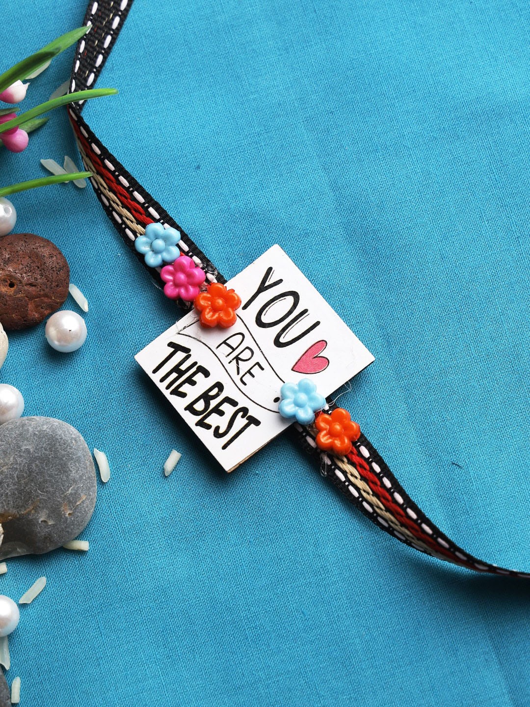 

Aapno Rajasthan White Feel Good Rakhi with Roli Chawal & Greetings Card