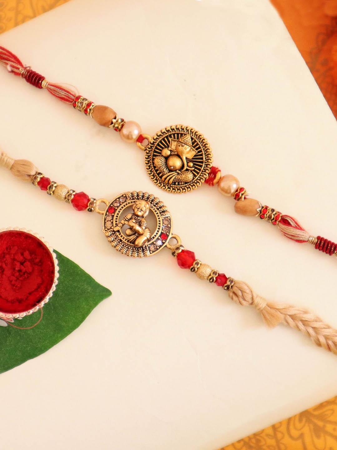 

TIED RIBBONS Set of 2 Krishna & Ganesha Rakhi with Card & Roli Chawal Gift Pack, Gold