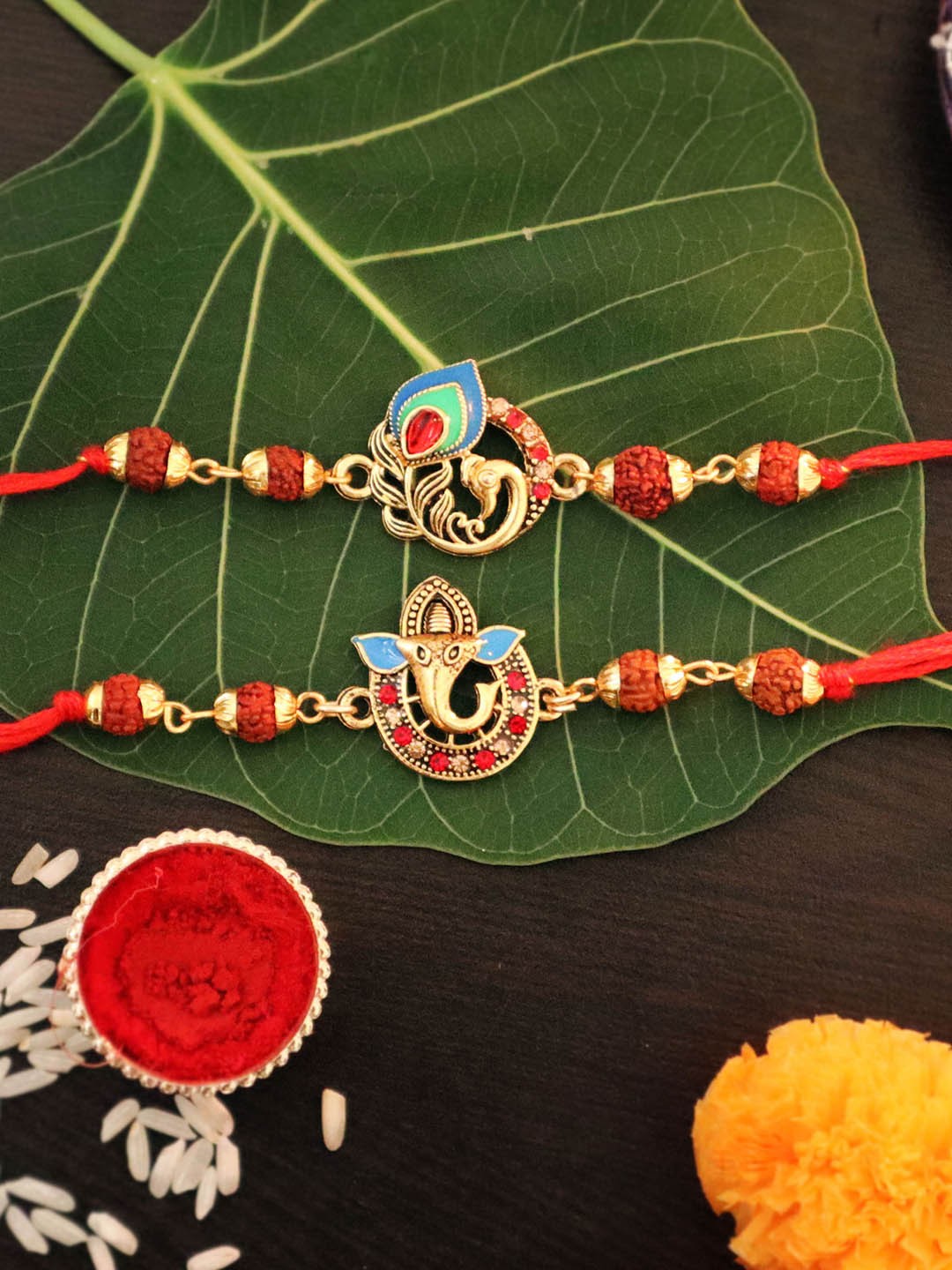

TIED RIBBONS Set of 2 Rudraksha Peacock & Ganesha Rakhi with Card & Roli Chawal, Gold