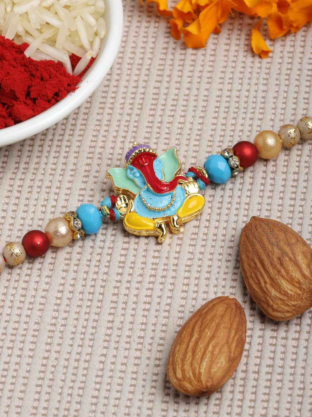 

PANASH Men Gold-Toned Ganesh Rakhi With Roli & Chawal