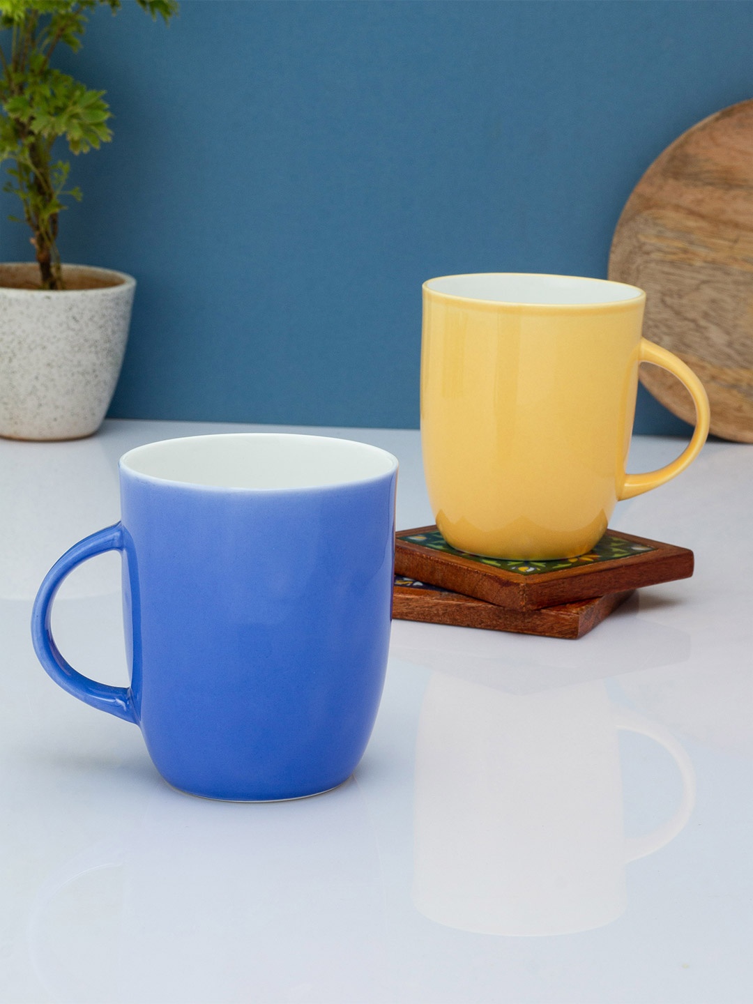 

CLAY CRAFT Blue & Yellow Solid Ceramic Glossy Mugs Set of Cups and Mugs