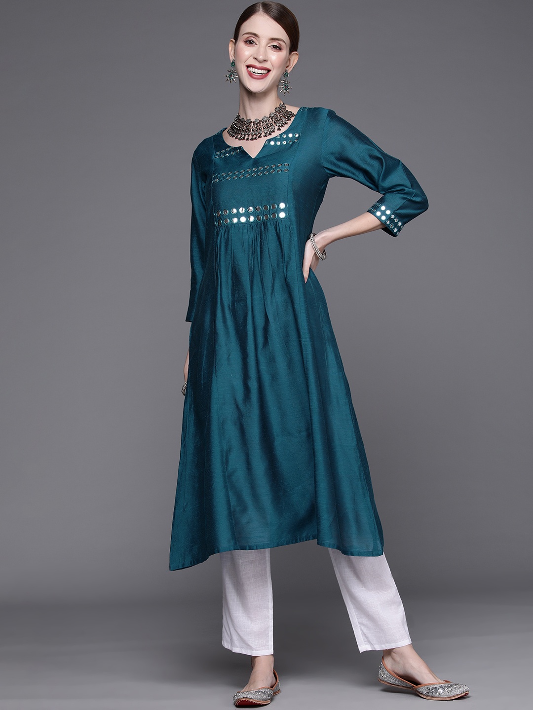 

Varanga Women Teal Green & Silver Yoke Design Mirror Work Kurta