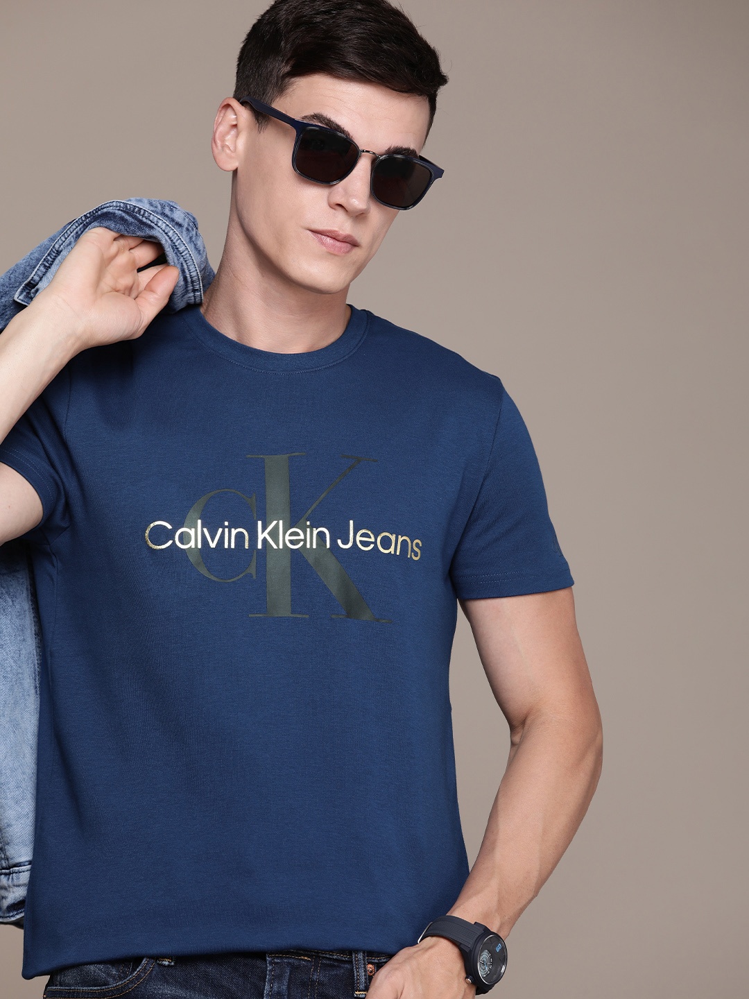 

Calvin Klein Jeans Men Blue & Gold-Toned Brand Logo Printed Pure Cotton T-shirt