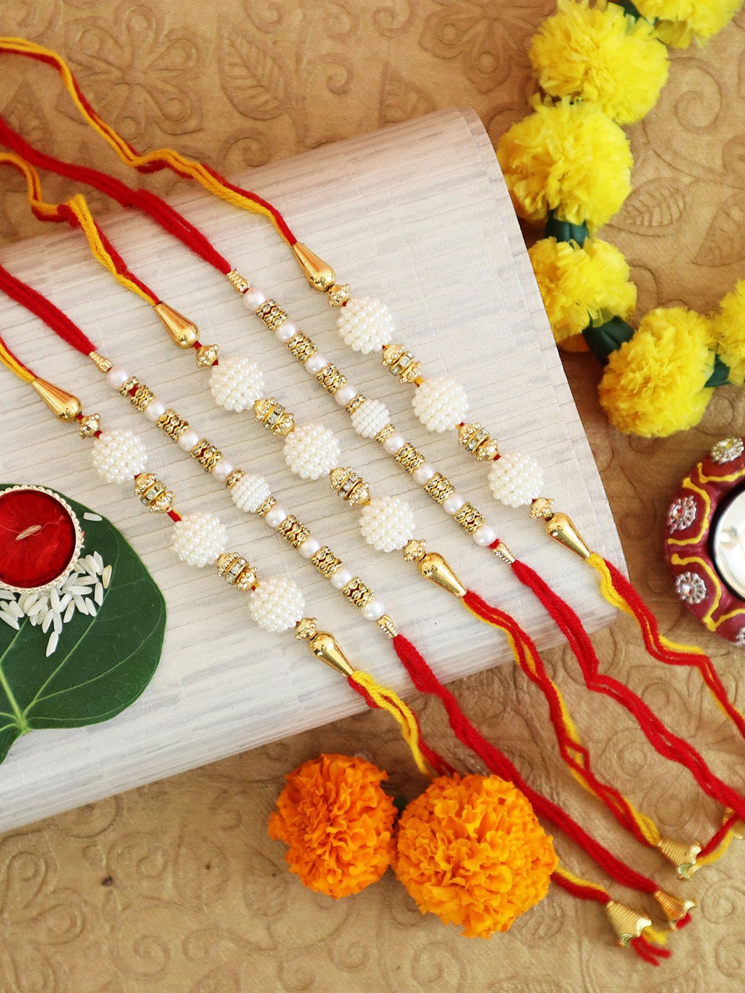 

TIED RIBBONS Set Of 5 White Pearl-Studded Rakhi With Card & Rolichawal, Multi