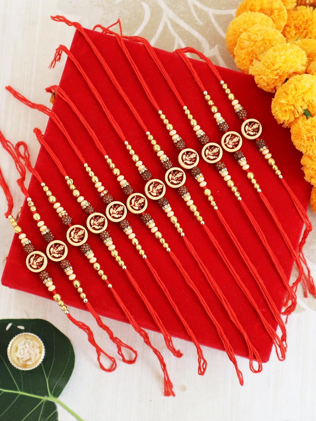 

TIED RIBBONS Set Of 12 Om & Rudraksha Rakhi, Card & Roli Chawal Gift Set, Red