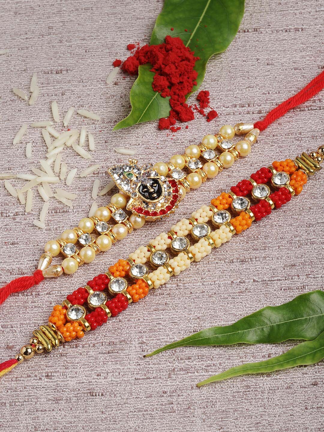 

PANASH Gold-Toned Krishna Rakhi & Lumba Set with Roli Chawal