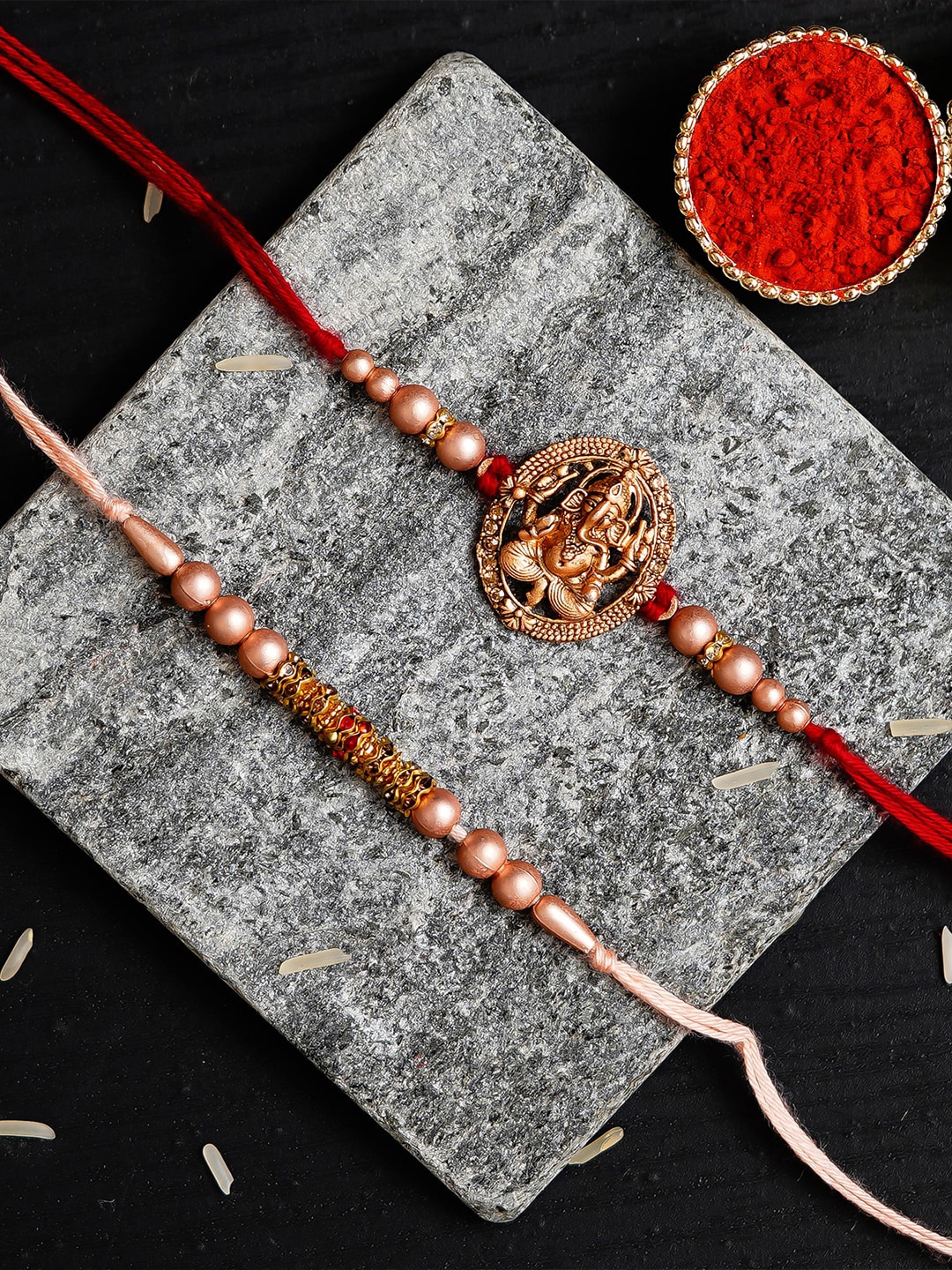 

eCraftIndia Pack Of 2 Rose Gold Ganesha Designer Rakhis & Roli Chawal Pack