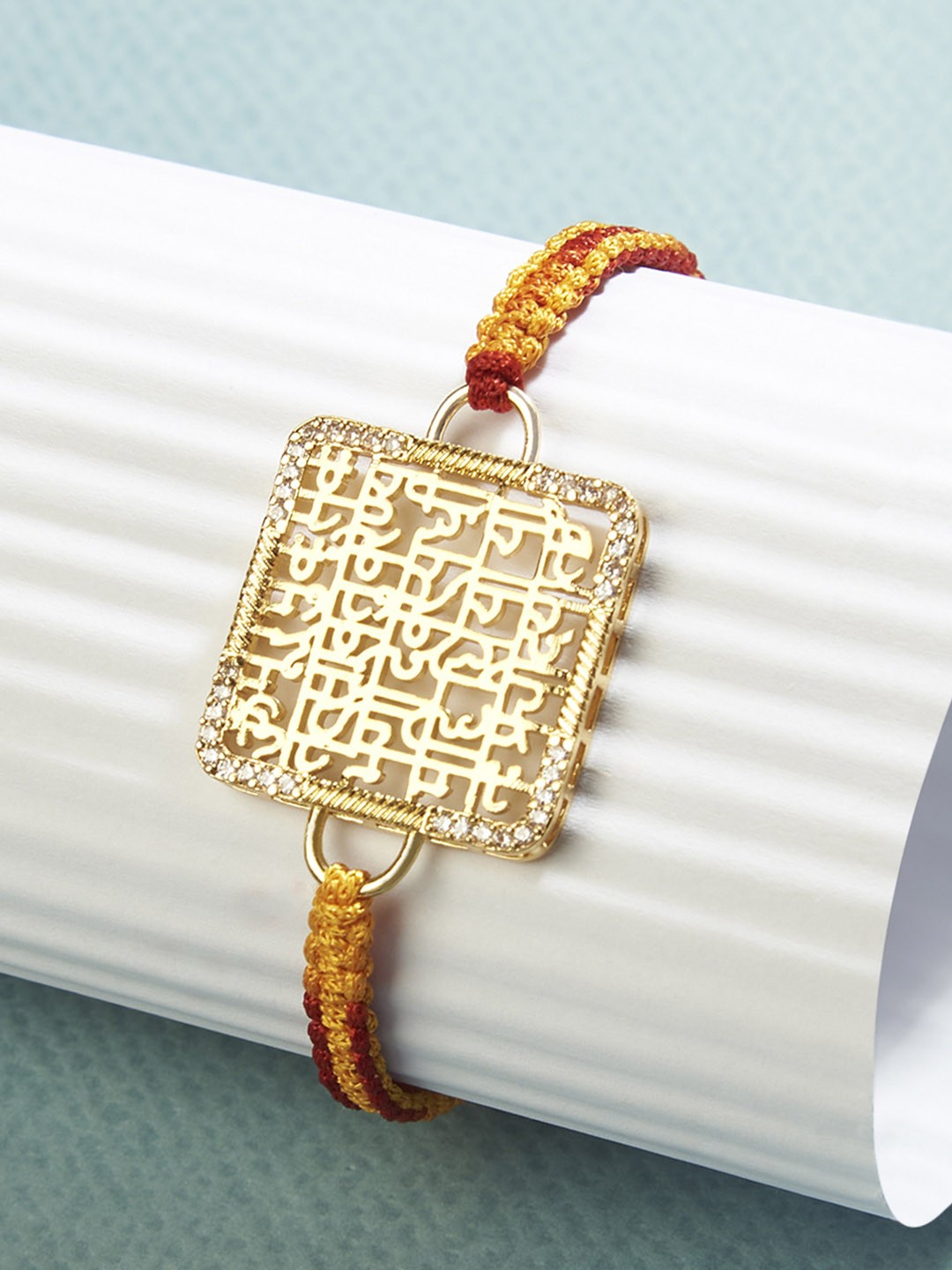 

MINUTIAE Gold-Toned Gayatri Mantra Textured Rakhi