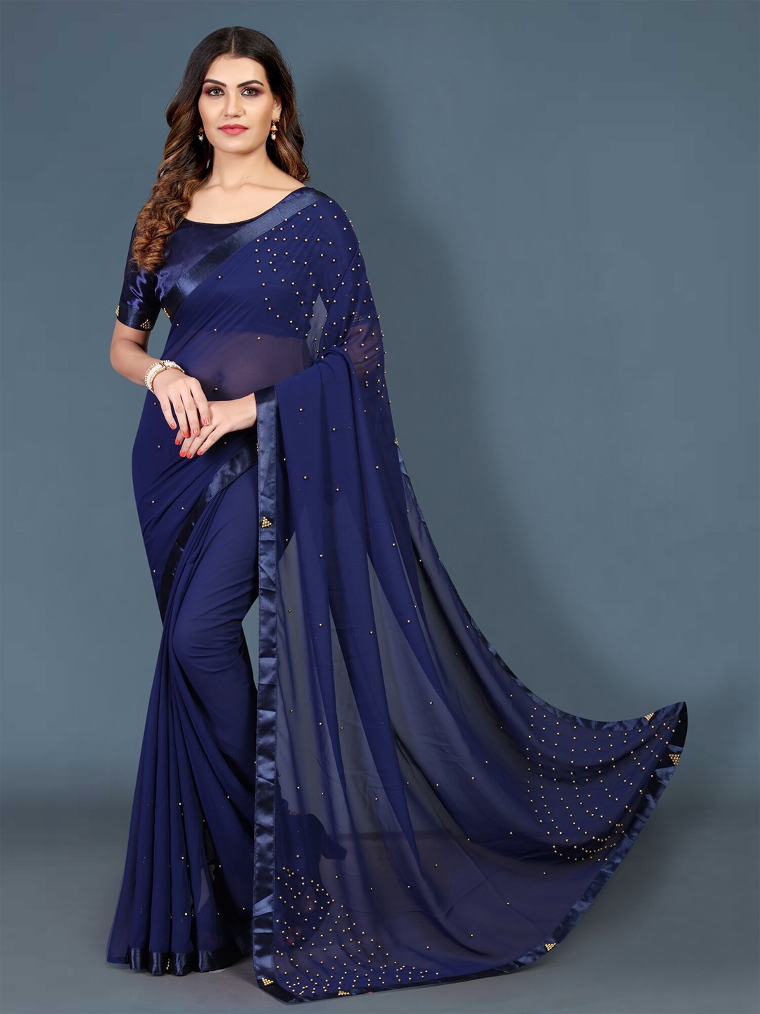 

APNISHA Navy Blue & Gold-Toned Embellished Beads and Stones Pure Georgette Saree