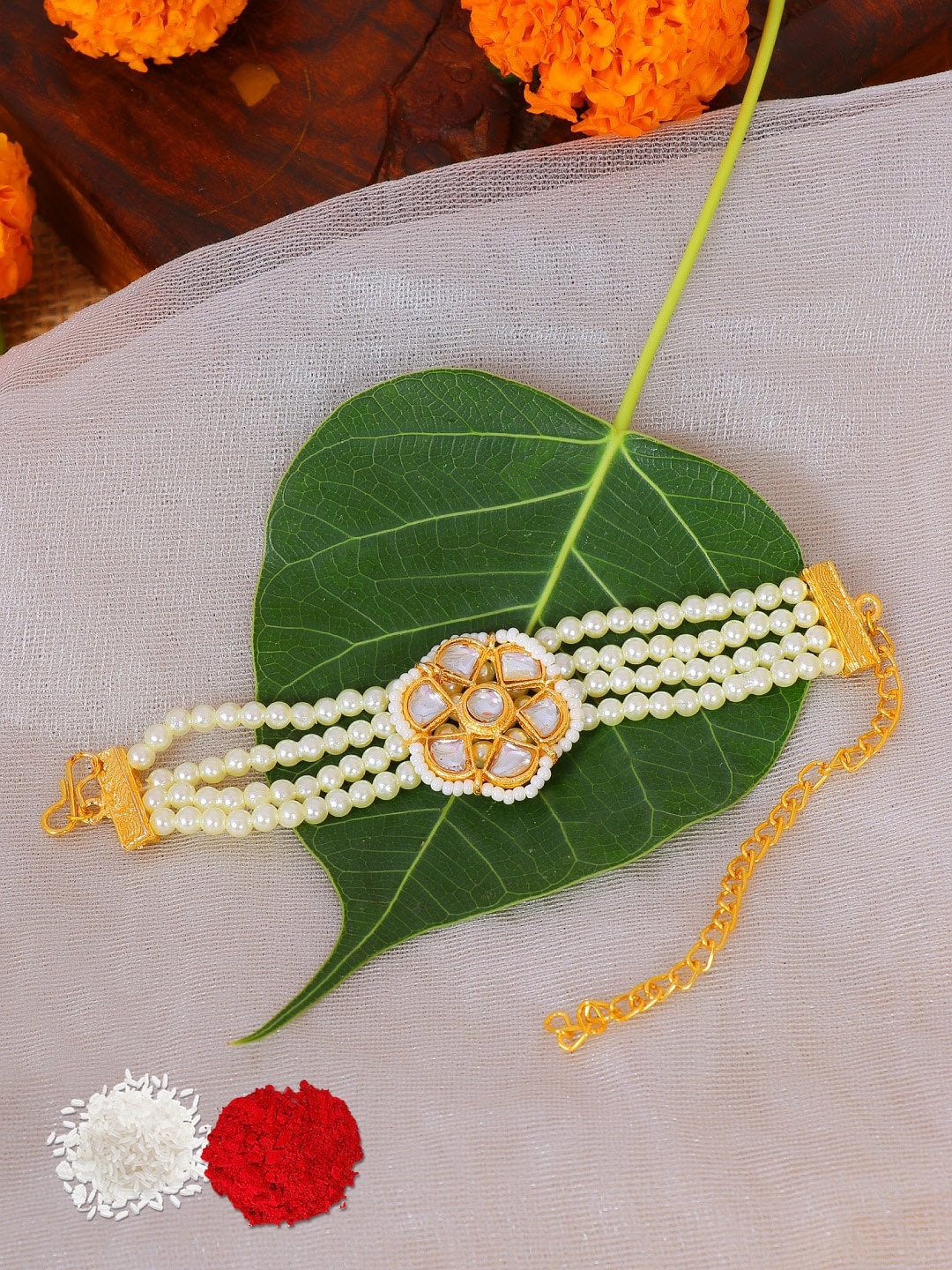 

Crunchy Fashion Women Gold-Plated & White Kundan-Studded Rakhi With Roli Chawal