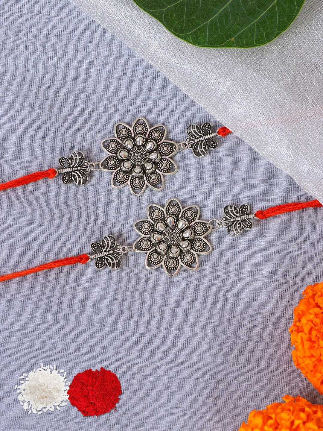 

Crunchy Fashion Women Set Of 2 Silver-Toned Floral Design Oxidised Rakhi