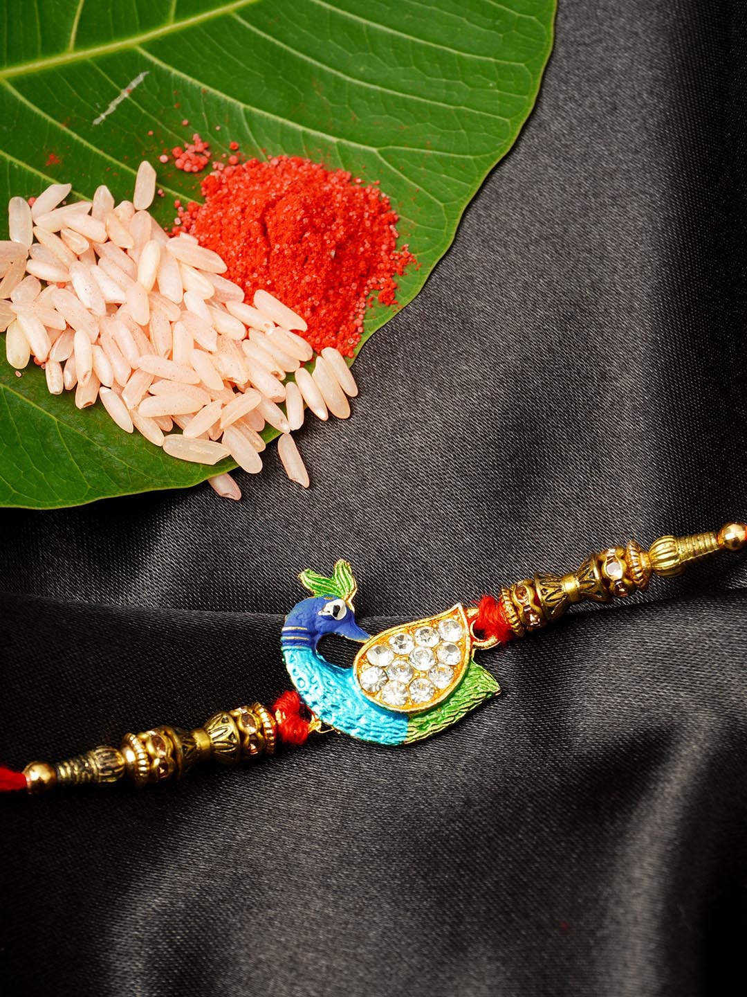 

Urmika Men Gold-Toned & Blue Designed Rakhi