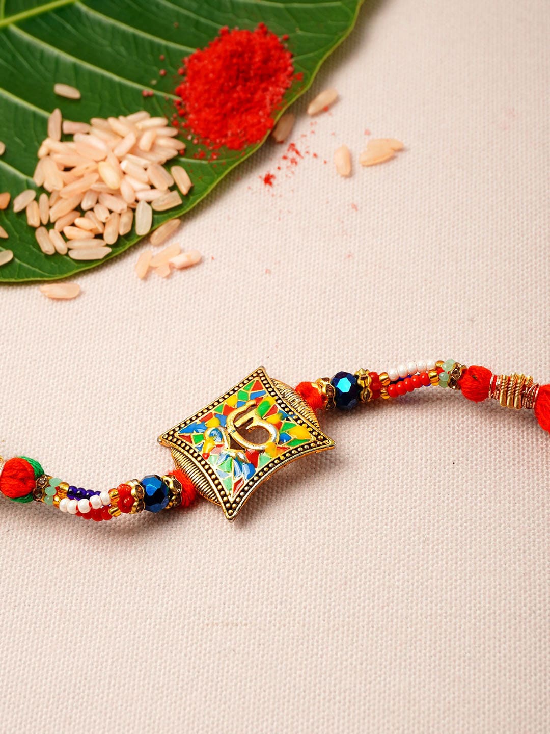 

Urmika Men Red & Green Om Rakhi
