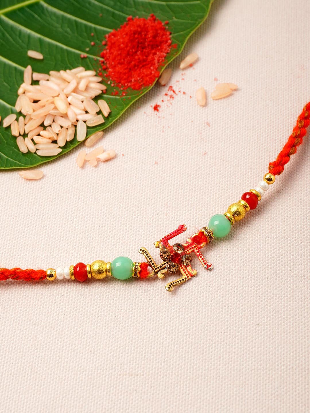 

Urmika Men Gold-Toned Red & Blue Stone-Studded & Beaded Rakhi