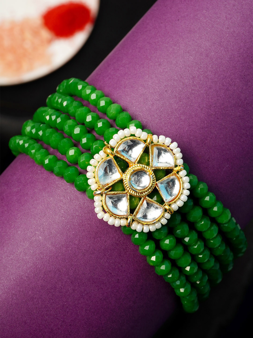

Urmika Men Green Beaded Rakhi With Roli Chawal