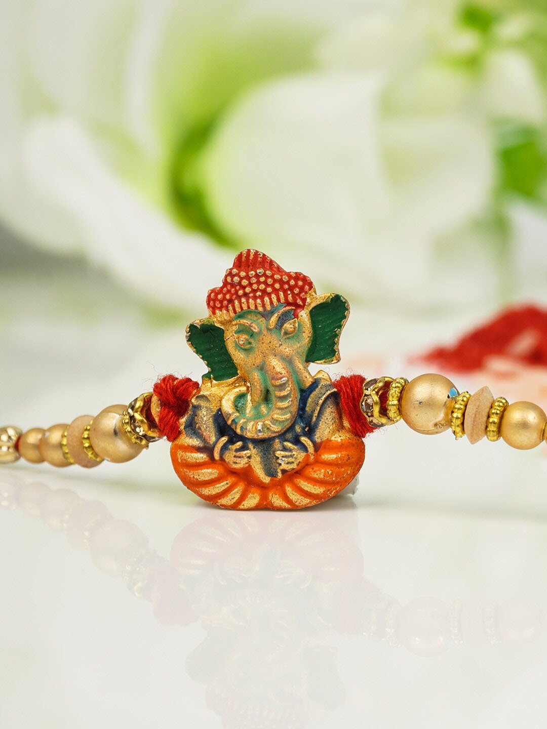 

Urmika Men Gold-Toned Red & Green Beaded Ethnic Rakhi With Roli Chawal