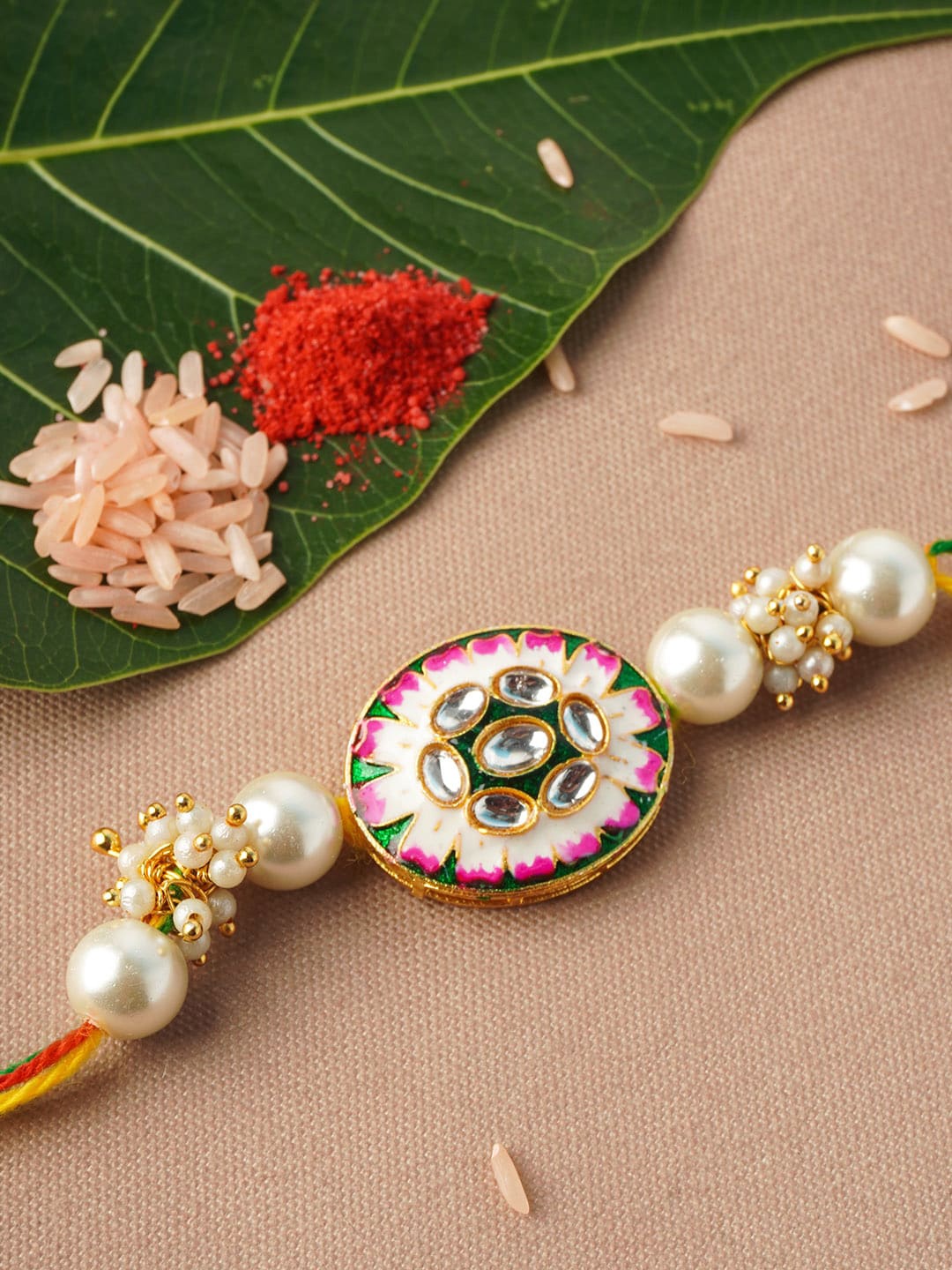 

Urmika Men White & Gold-Toned Flower Motif Pearl Rakhi