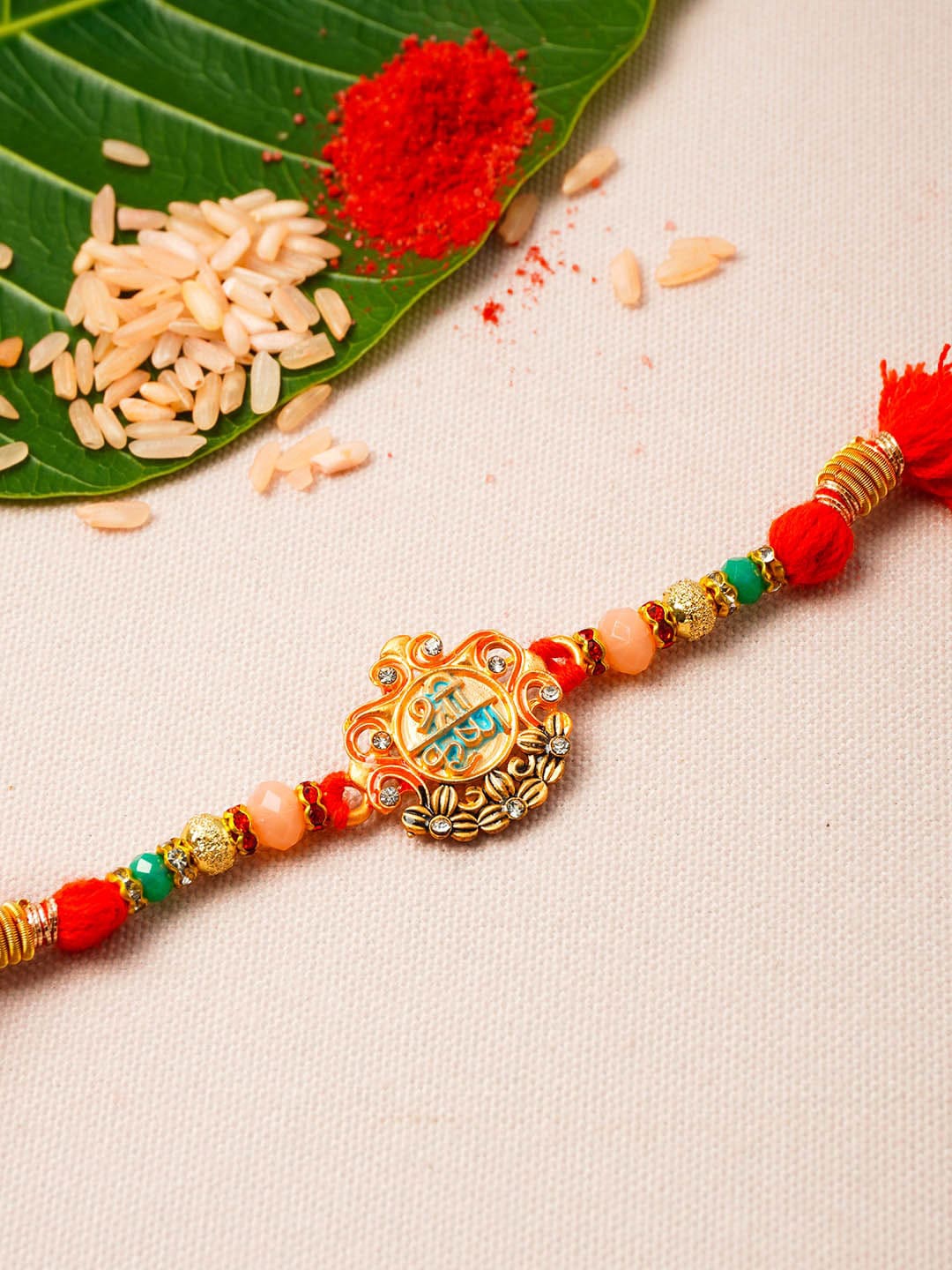 

Urmika Men Stone-Studded & Beaded Rakhi With Roli Chawal, Gold