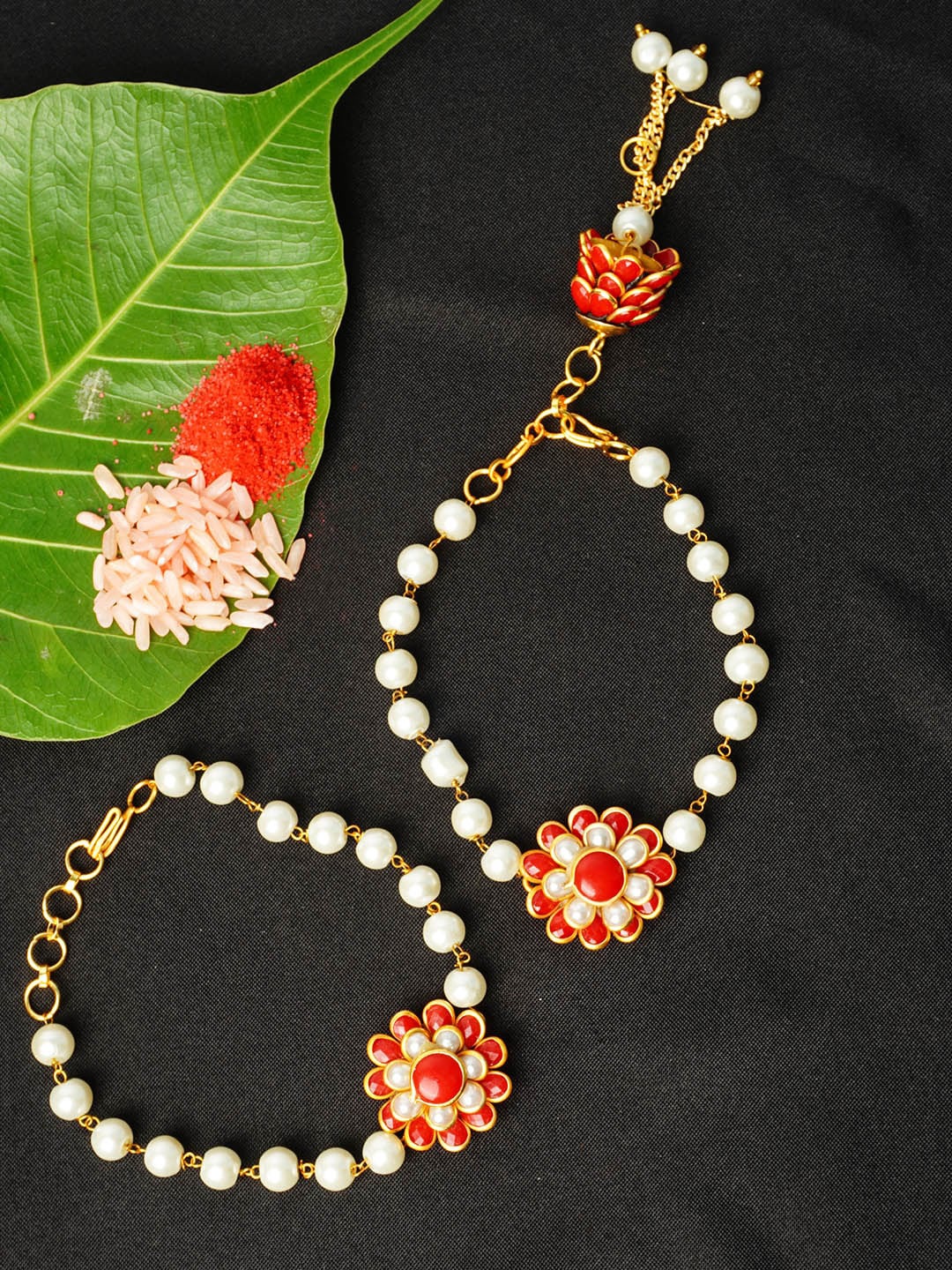 

Urmika Pack of 2 Red & White Floral Rakhis With Roli Chawal