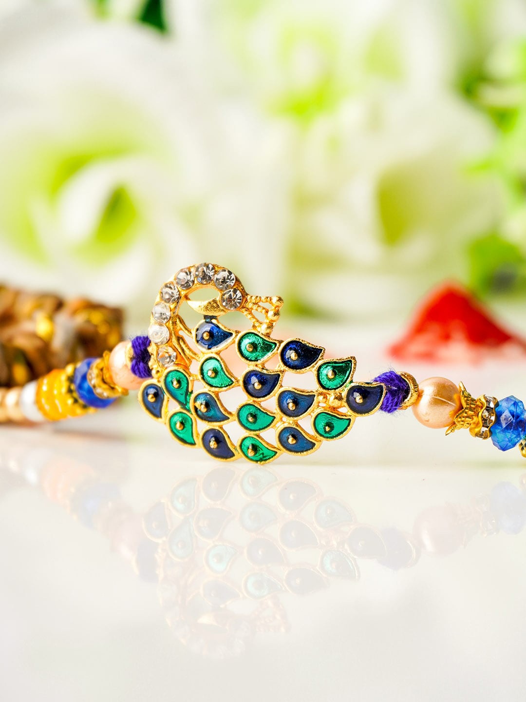 

Urmika Men Gold-Toned White & Blue Stone-Studded & Beaded Rakhi