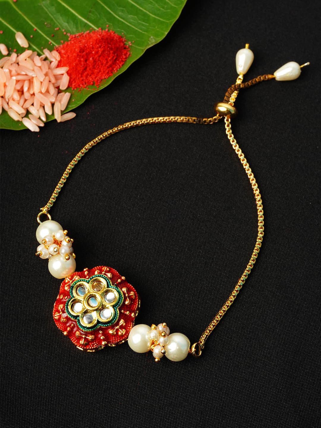 

Urmika Men Gold-Toned & White Crystal Studded & Beaded Rakhi & Roli Chawal