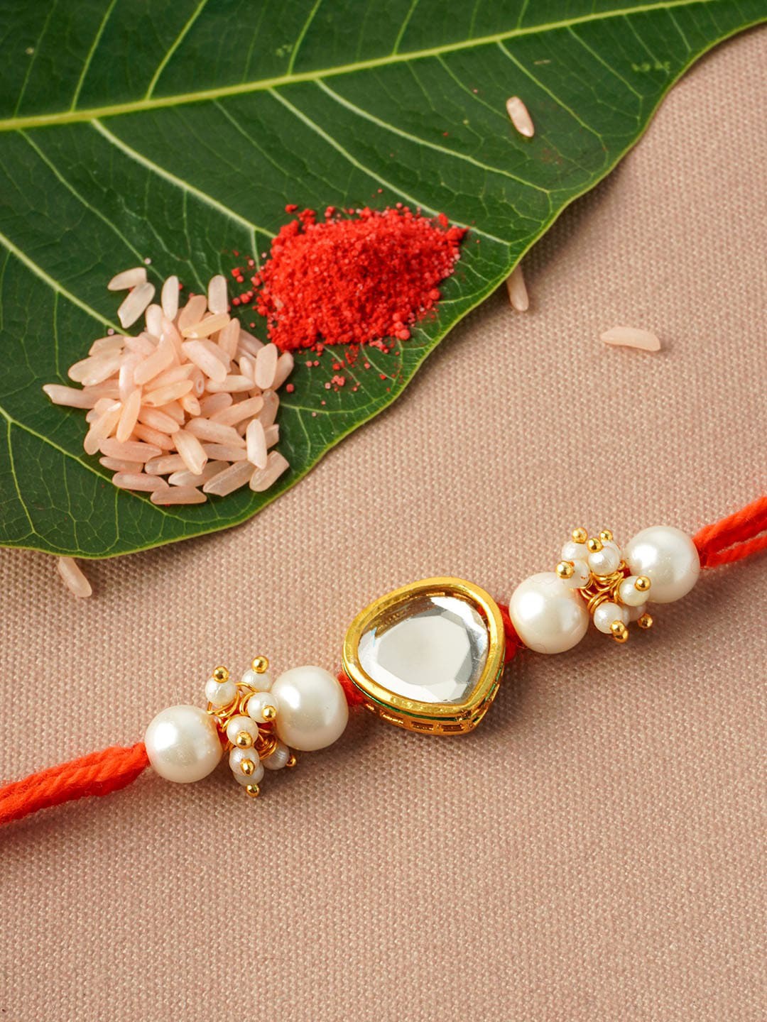 

Urmika Men White & Red Heart Beaded Rakhi