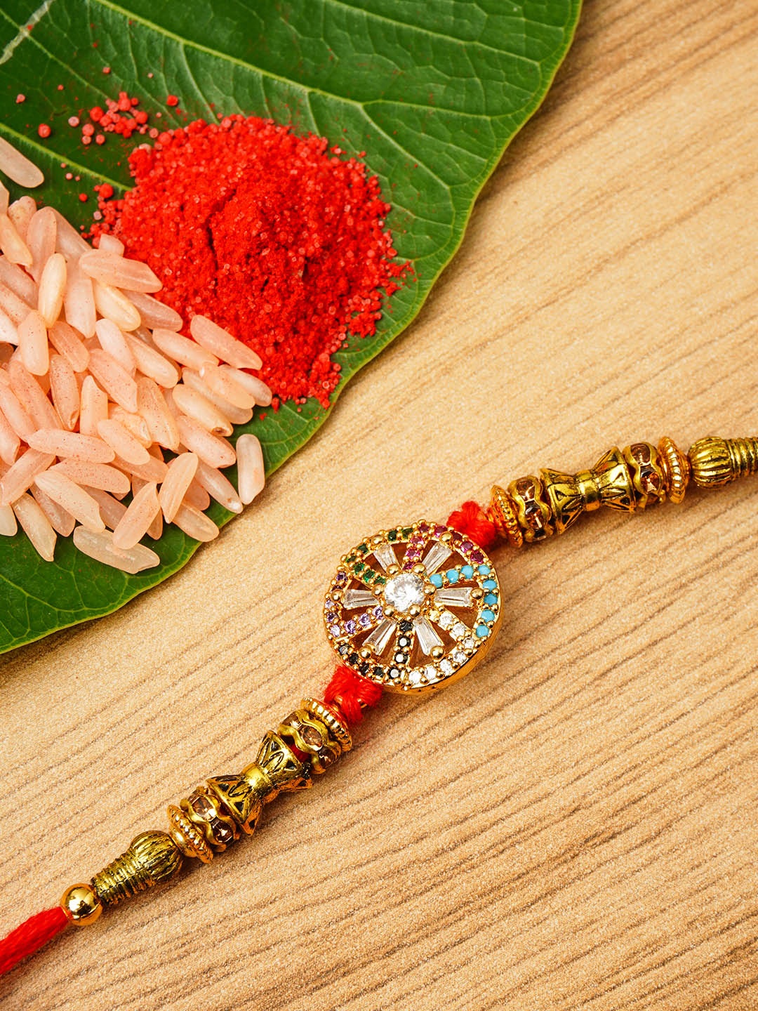 

Urmika Men Gold-Toned Ethnic Rakhi With Roli Chawal