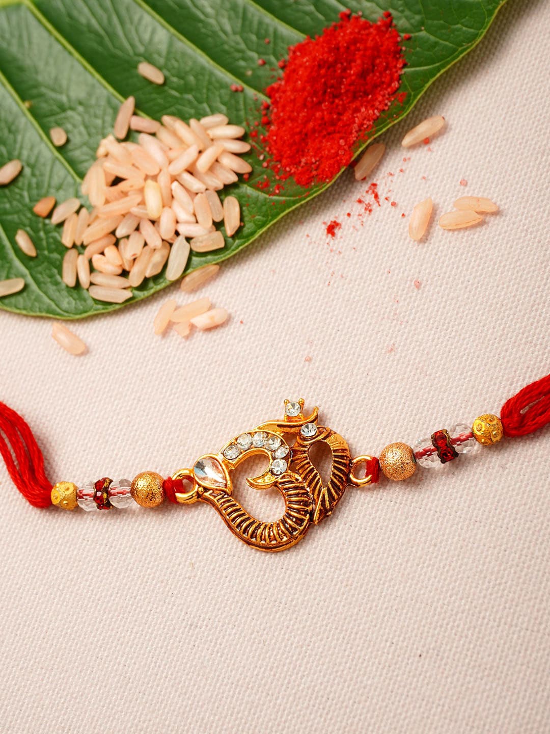 

Urmika Men Gold-Toned & Maroon Beaded Rakhi