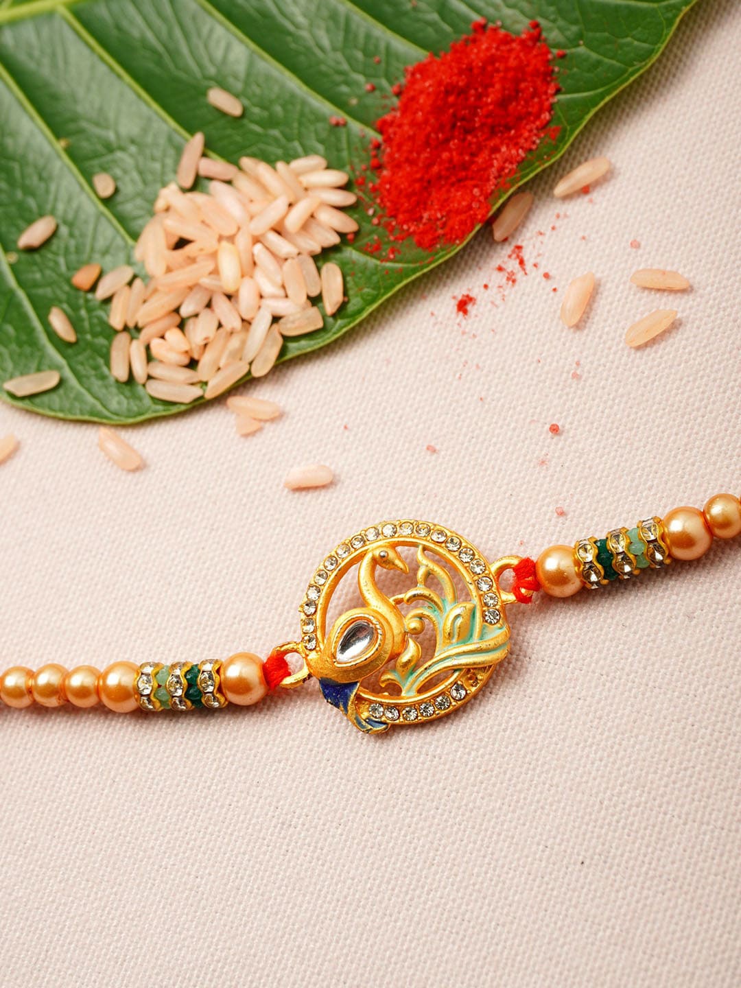 

Urmika Men Gold-Toned White & Green Stone-Studded & Beaded Rakhi