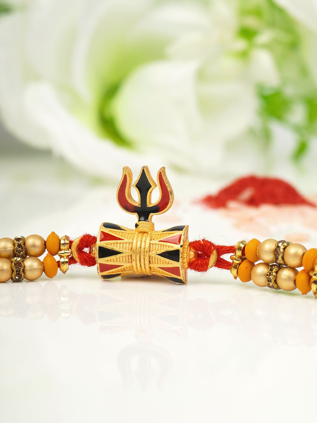 

Urmika Men Gold-Toned Drum Trishul Rakhi With RolI Chawal