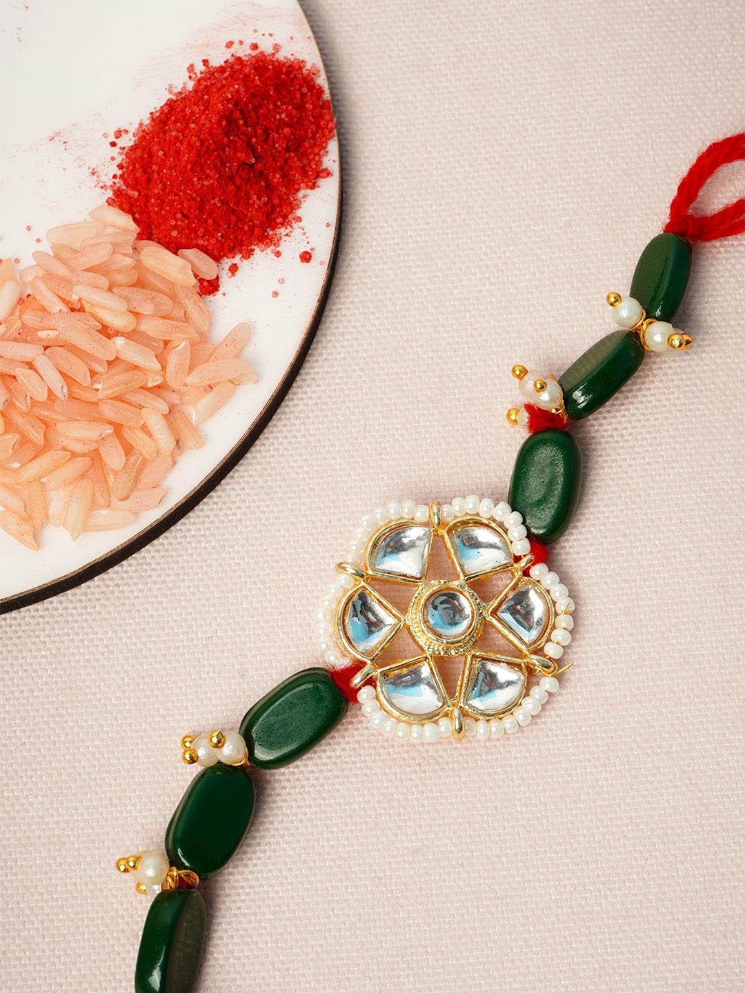 

Urmika Men Green & White Beaded Rakhi With Roli Chawal