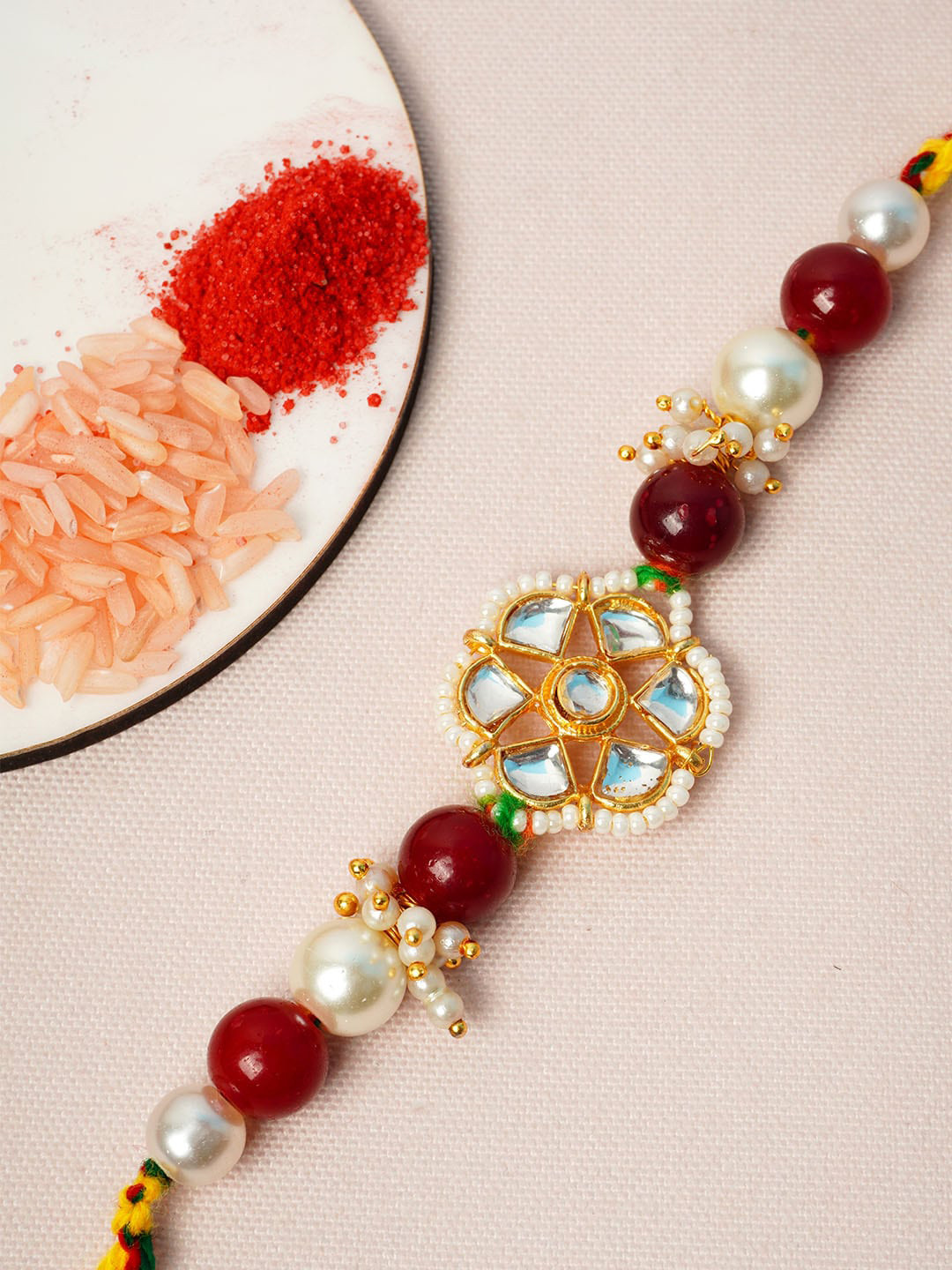

Urmika Men Gold-Toned White & Red Stone-Studded & Beaded Rakhi