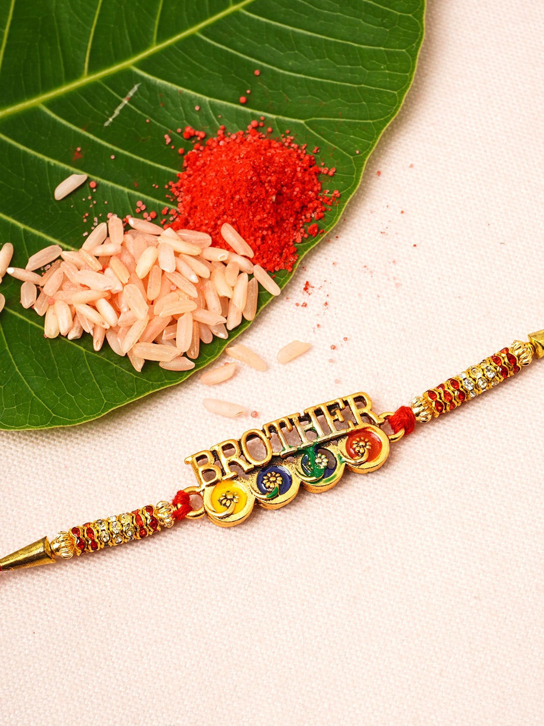 

Urmika Men Gold-Toned & Red Stone-Studded & Beaded Brother-Charm Rakhi With Roli Chawal