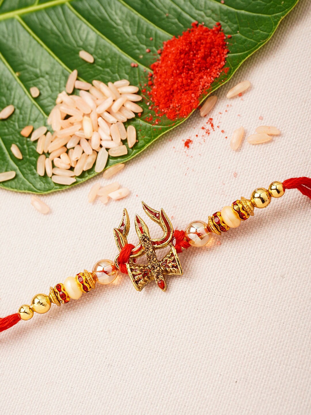 

Urmika Men Gold Toned & Off White Beaded Rakhi