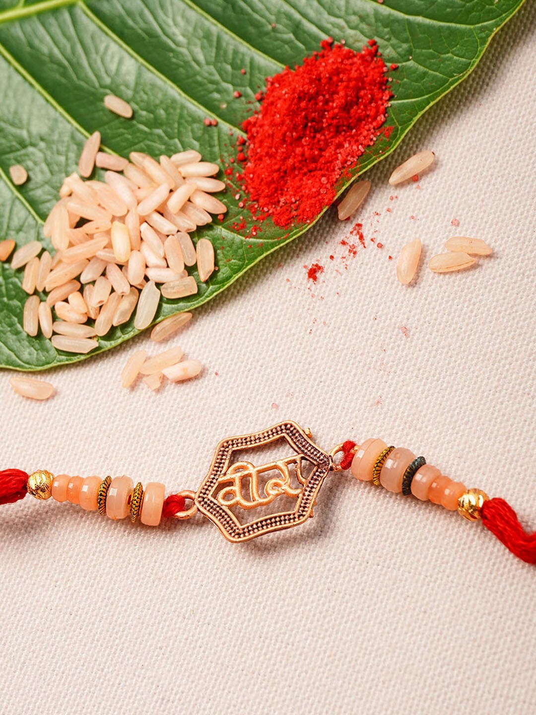 

Urmika Men Orange & Maroon Beaded Rakhi