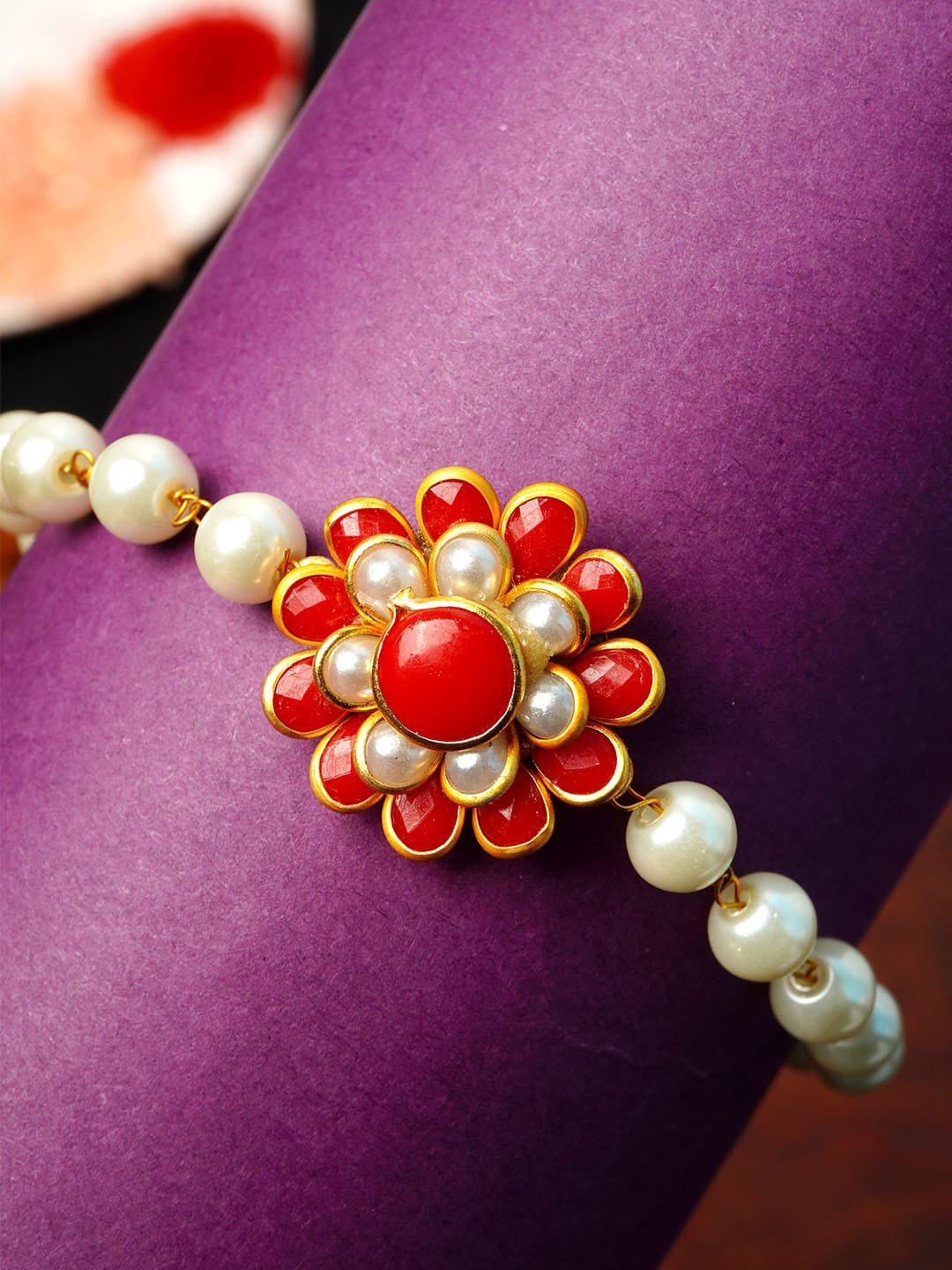 

Urmika Men White & Red Flower Rakhi & Roli Chawal