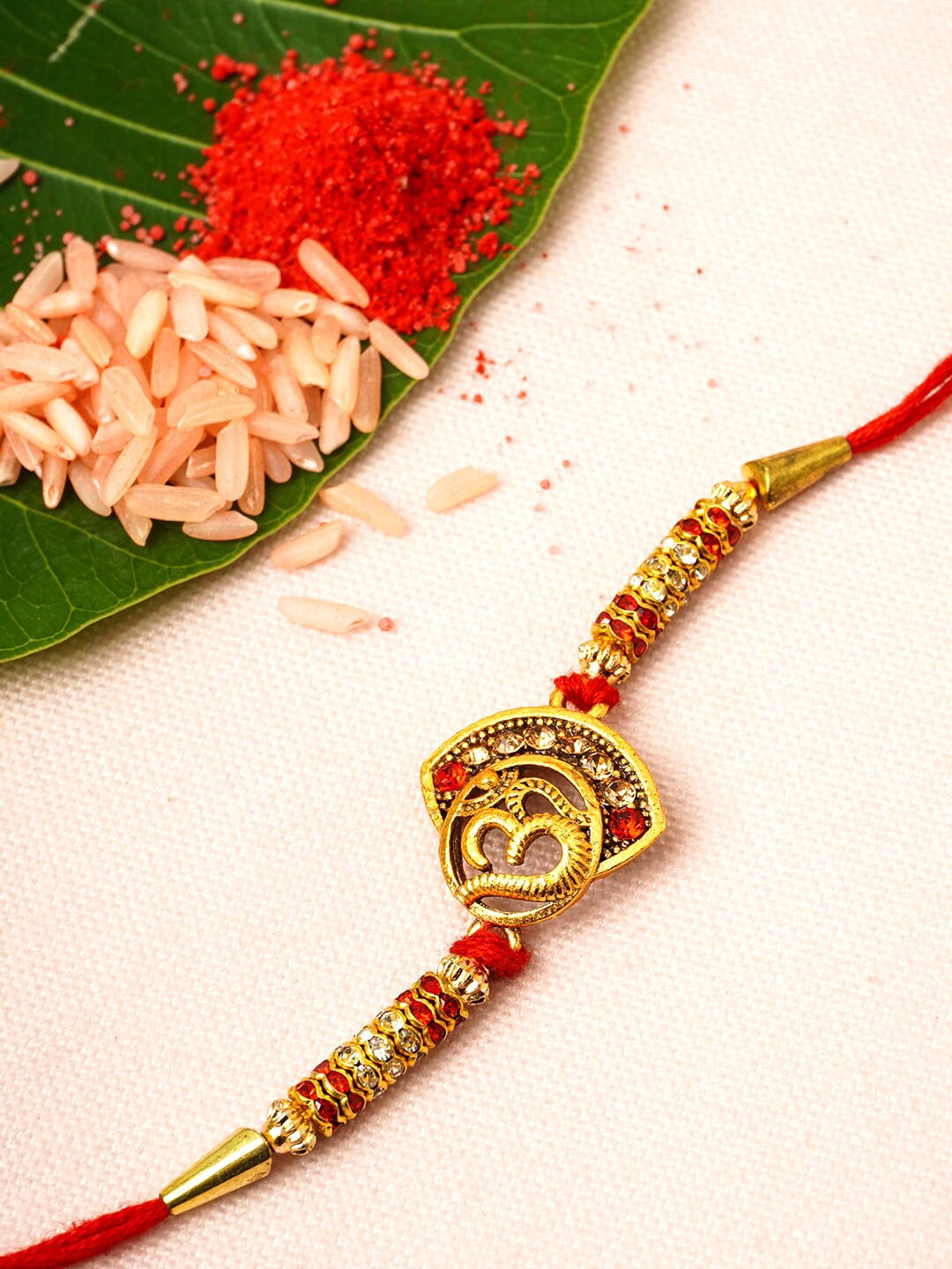 

Urmika Men Gold-Coloured Om Ethnic Rakhi With Rolichawal